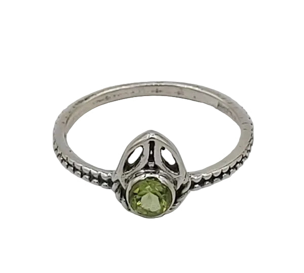 Silver ring with a green gemstone on a white background