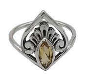 Silver ring with a yellow gemstone on a white background