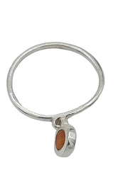 Silver ring with a small orange stone on a white background