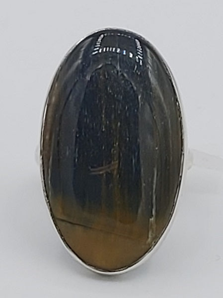 Rings with a large oval gemstone on a white background