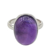 Silver ring with a purple gemstone on a white background