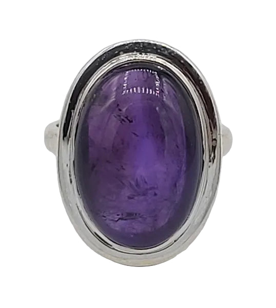 Ring with a purple gemstone and silver setting on a white background