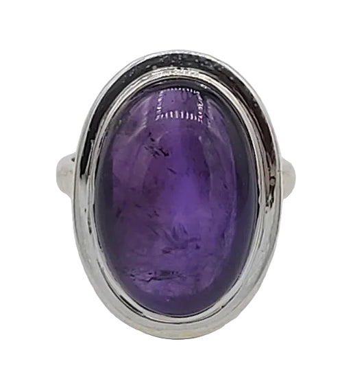 Ring with a purple gemstone and silver setting on a white background
