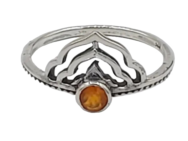 Silver ring with a central orange stone on a white background