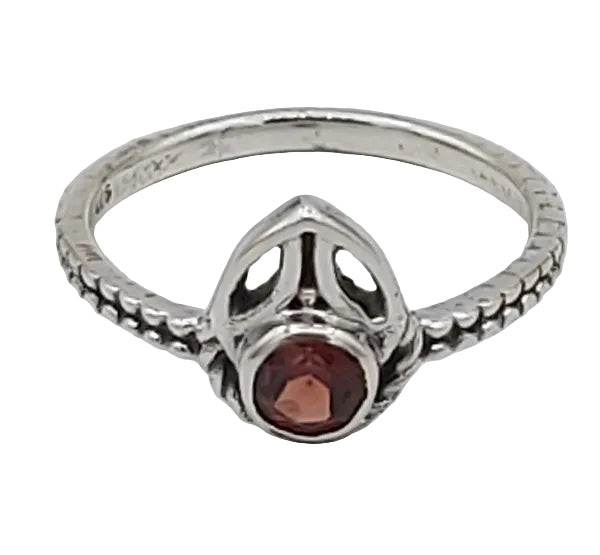 Silver ring with a red gemstone on a white  background
