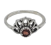 Silver ring with a central brown gemstone on a white background