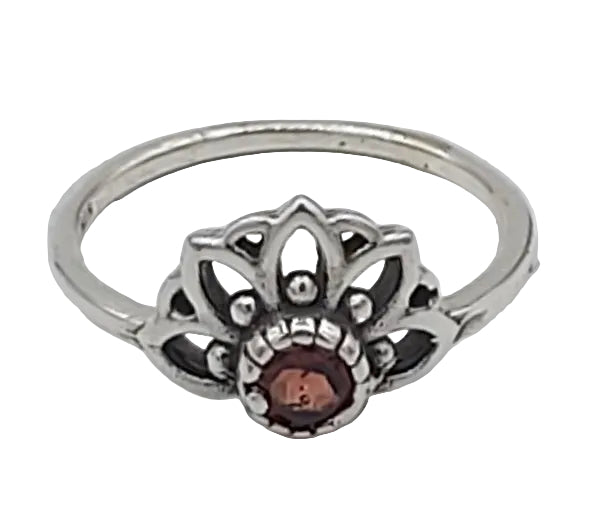 Silver ring with a central brown gemstone on a white background