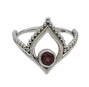 Silver ring with a red gemstone on a white background
