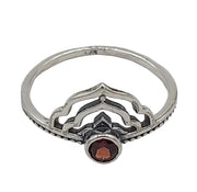 Silver ring with a red gemstone on a white  background