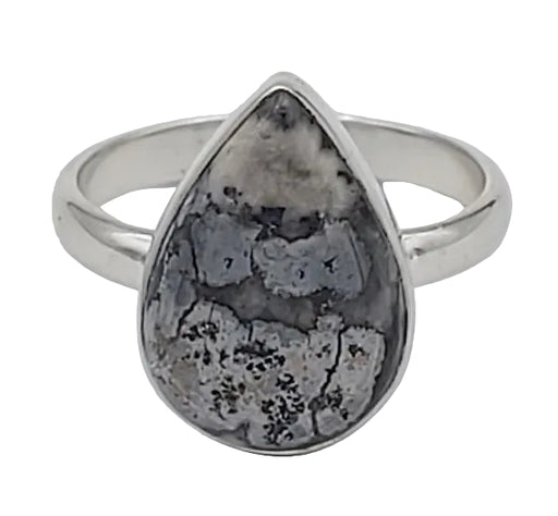Silver ring with a teardrop-shaped stone on a white background
