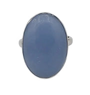 Silver ring with a blue stone on a white  background