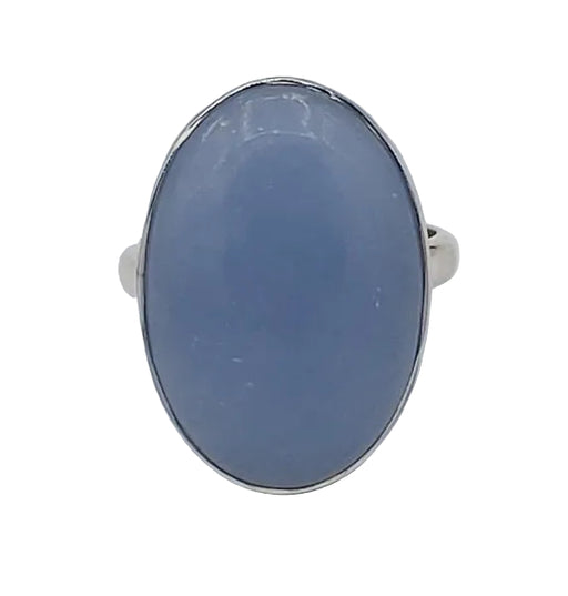 Silver ring with a blue stone on a white  background