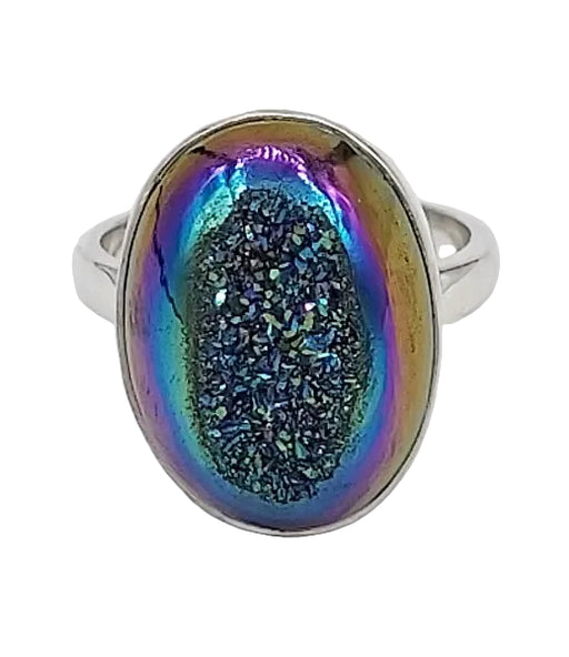 Ring with a colorful, iridescent stone on a white background