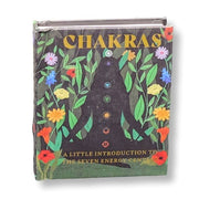 Book titled 'Chakras' with illustrations of a person and flowers on the cover.