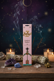Incense packaging with incense sticks on a mystical background with candles and crystals.