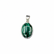Green malachite pendant on a silver chain with a ruler for scale on a white background