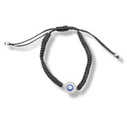 Black braided bracelet with a blue evil eye charm on a white background