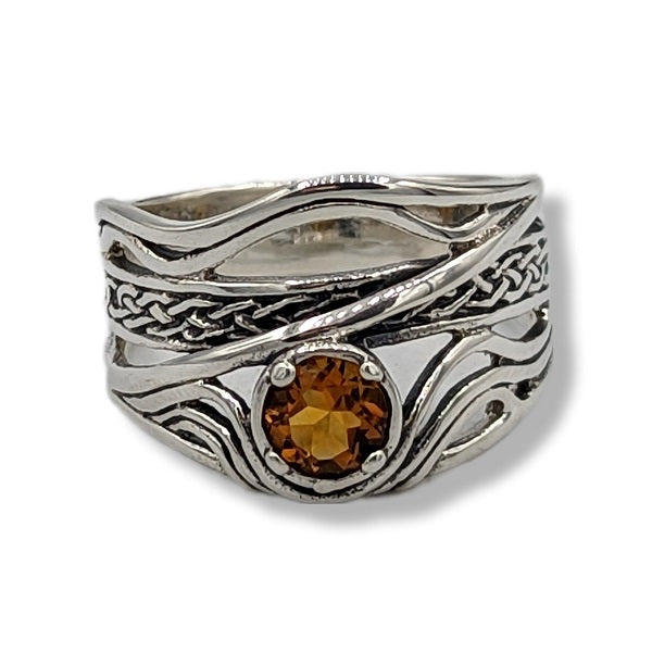 a wavy sterling silver ring with citrine on a white background