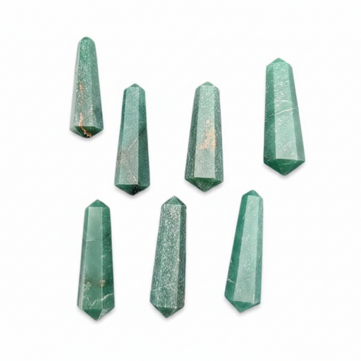 Seven faceted green crystal points arranged on a plain white background.