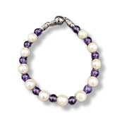 Bracelet with purple and white beads on a white background