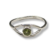 Silver ring with a green gemstone on a white background