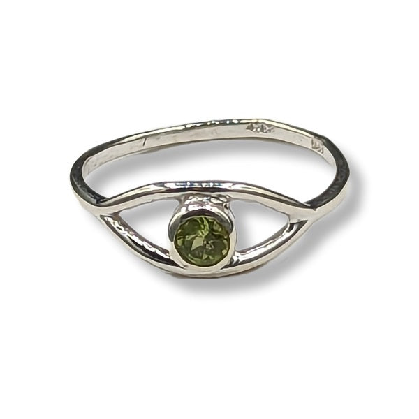 Silver ring with a green gemstone on a white background