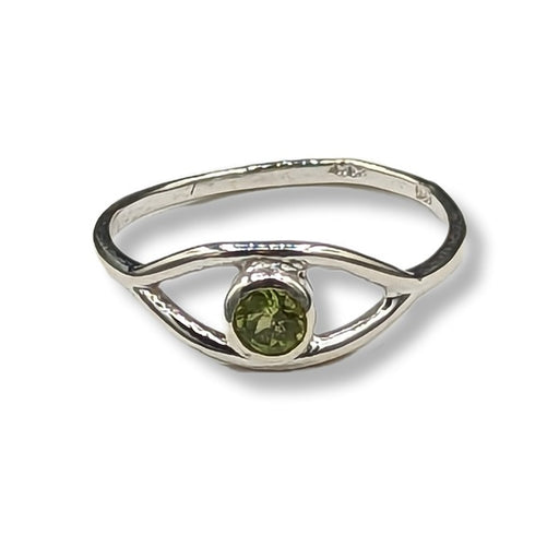 Silver ring with a green gemstone on a white background