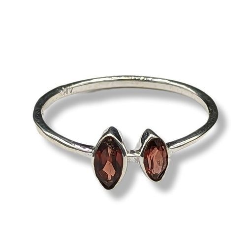 Silver ring with two red gemstones on a white background