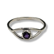 Silver ring with a purple gemstone on a white background