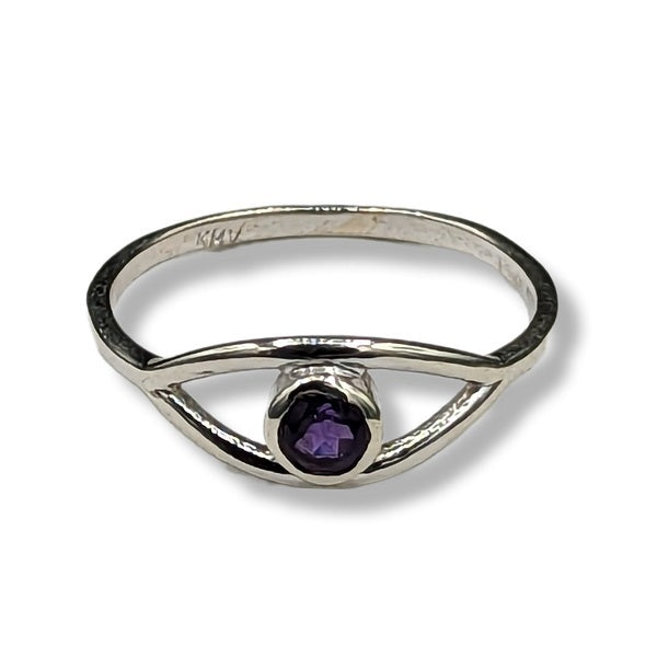 Silver ring with a purple gemstone on a white background