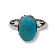 Silver ring with a turquoise stone on a white background