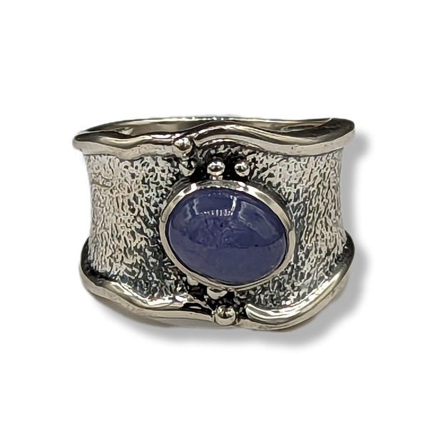 Silver ring with a blue stone on a white background