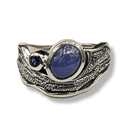 Silver ring with blue gemstone on a white background