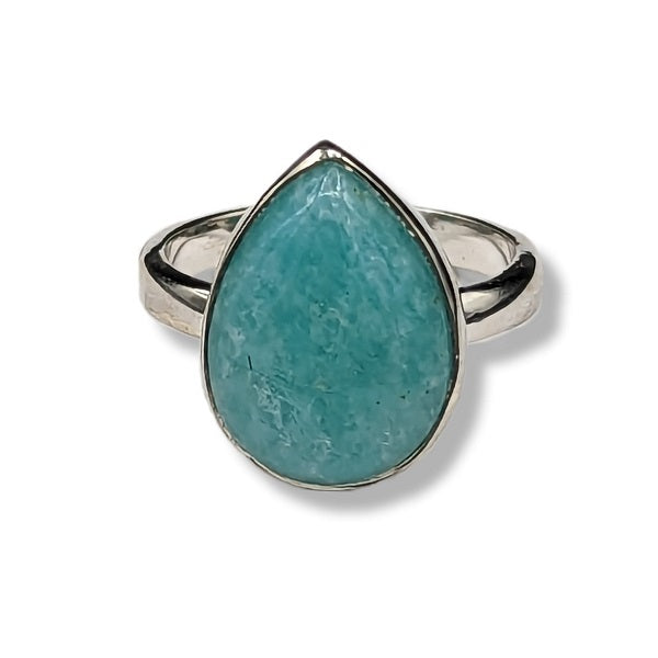 Teardrop-shaped turquoise stone ring with silver band on a white background