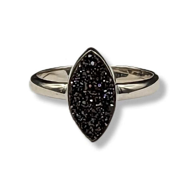 Silver ring with a black gemstone on a white background