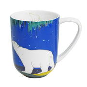A ceramic mug featuring a polar bear design on a blue background with a white handle and white interior.