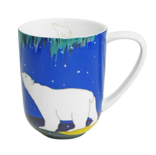 A ceramic mug featuring a polar bear design on a blue background with a white handle and white interior.