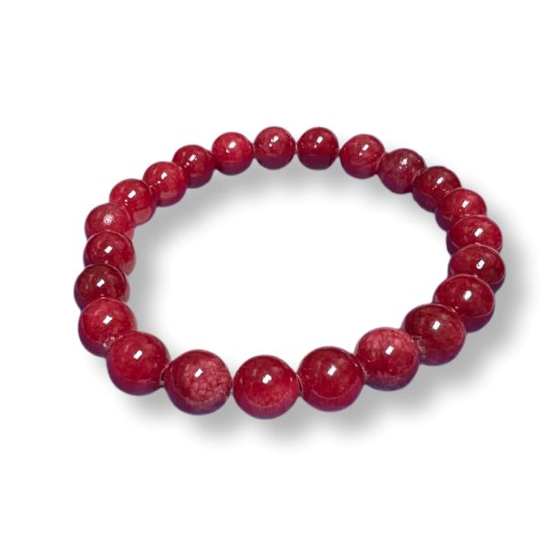 A beaded stretch bracelet made of polished, round red gemstone beads, displayed on a clean white background with a soft drop shadow.