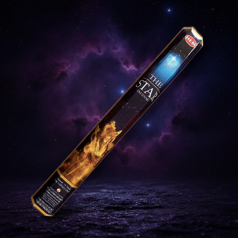 A single incense stick package labeled 'The Star ' , shown diagonally against a dramatic starry night sky background with purple clouds and a dark reflective surface.
