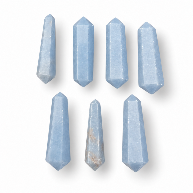Seven faceted light blue crystal points arranged in two rows on a clean white background.