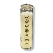 Candle in a glass jar with moon phase design on a white background