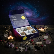 Open box of crystals with a 'Gemini' label against a cosmic background