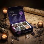 Crystal kit for Sagittarius with candles and herbs on a wooden surface