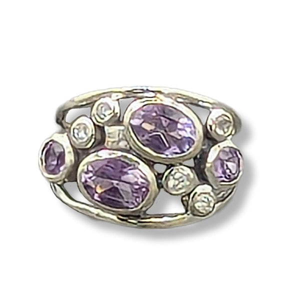 Silver ring with purple gemstones on a white background