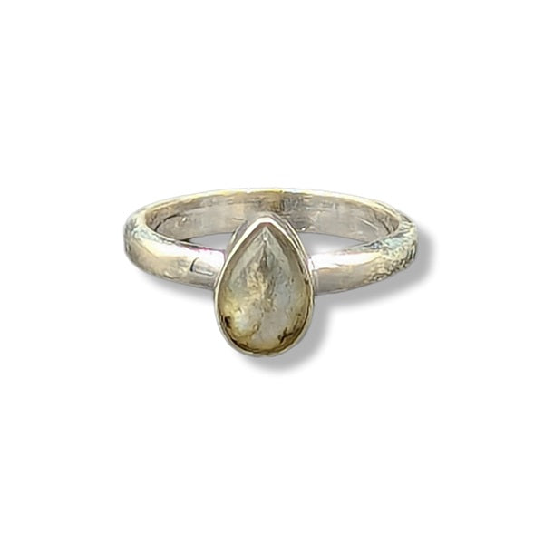 Silver ring with a teardrop-shaped gemstone on a white background