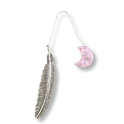 Bookmark with a feather pendant and pink crescent moon charm on a white background