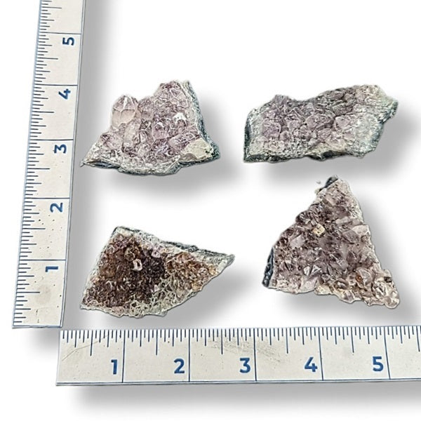 Mineral samples with a ruler for scale on a white background