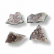 Four crystal rock specimens on a white background