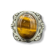 Silver ring with a large yellow gemstone on a white background