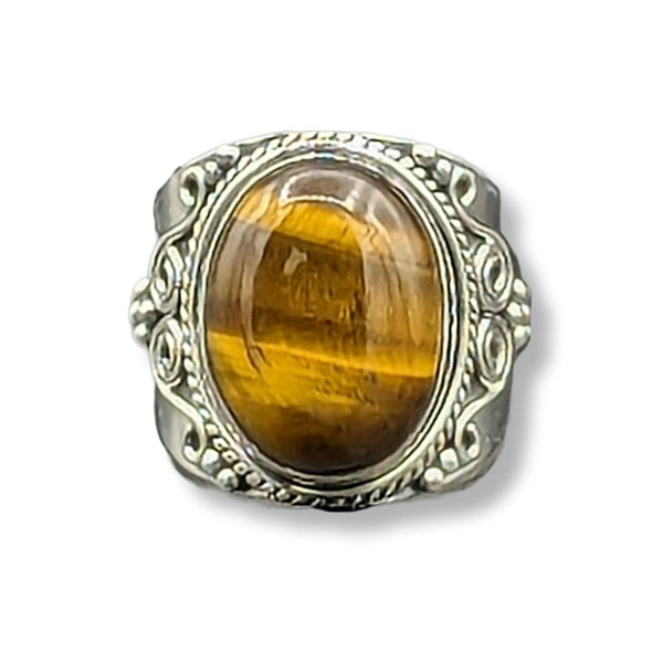 Silver ring with a large yellow gemstone on a white background
